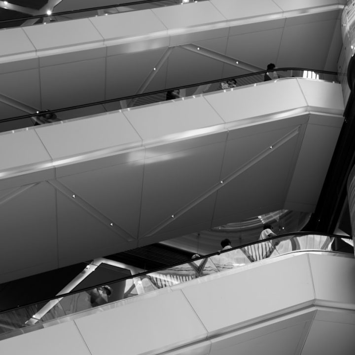 A black and white photo of an escalator